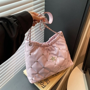 Lavender quilted chain bucket bag with silver star emblem and glossy faux leather finish