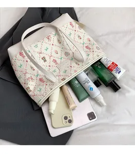 Internal view of floral tote bag showing large capacity with various daily essentials