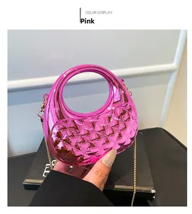 Detailed view of a pink acrylic mini crescent bag with quilted texture and gold chain