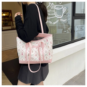 Detail of floral tote bag showing embossed fabric and cute pink cartoon pattern