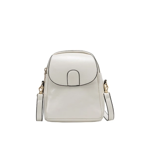 Minimalist white textured mini crossbody bag with golden hardware and flap closure