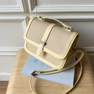 Light yellow straw-texture crossbody bag with leather trim and silver metal clasp