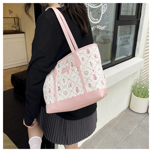 Detail of sweet floral tote bag with pink leather trim and cute bear illustration print