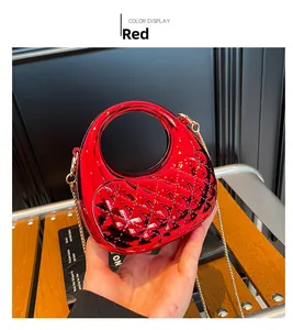 A detailed view of a stylish red quilted acrylic mini crescent moon evening bag.