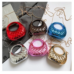 Close-up of candy-colored acrylic mini bags with diamond quilting and chain straps.