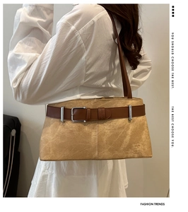 Detail of khaki suede baguette bag with leather buckle and slim shoulder strap