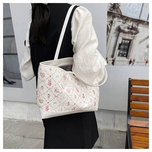 Close-up of printed white tote bag with cute cartoon bears and bubble texture fabric