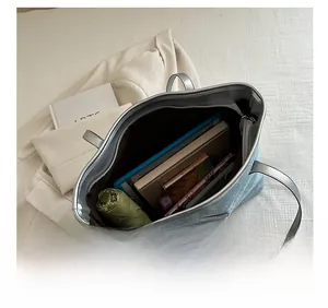 Top view of blue glitter tote bag showing spacious interior with tablet and daily items