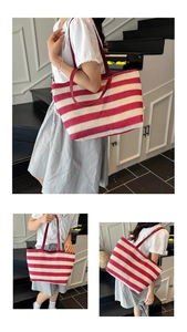 Detail of red and white striped woven tote bag with burgundy faux leather shoulder straps