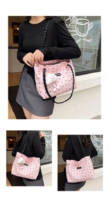 Pink quilted tote bag with black bow patterns and a plush cloud charm detail