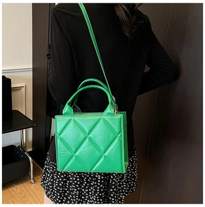 Détail du sac cabas matelassé vert vif avec motif en losange et bandoulière fine