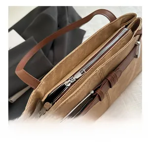 Detailed macro view showing smooth silver zipper and durable canvas tote bag texture