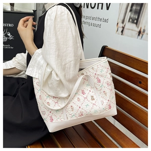 Floral cartoon print tote bag with pink bears shown in a casual lifestyle setting