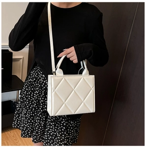 Détail du sac cabas blanc matelassé avec motif à losanges et bandoulière réglable pratique