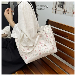 Detail of floral bear print tote bag with white faux leather trim and sturdy shoulder strap