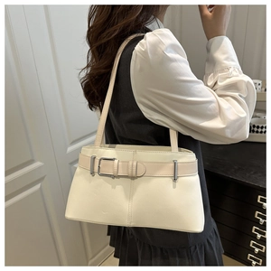 Detailed side view of the ivory shoulder bag with a stylish decorative belt buckle strap