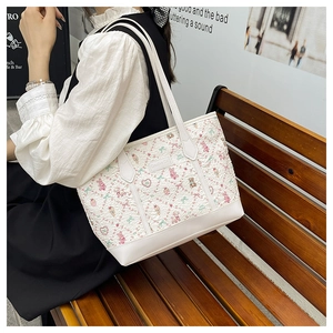 Detail of cute cartoon bear and flower prints on a large capacity white tote bag