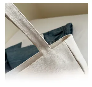 Macro shot of durable canvas tote bag showing reinforced stitching and premium fabric texture