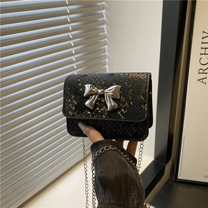 Chic black snakeskin embossed crossbody bag with a silver butterfly lock and chain strap