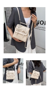 Detail view of cream PU leather backpack with decorative bows and pearl charm in use