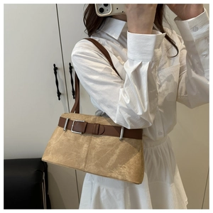 Close-up of khaki suede tote bag featuring brown leather trim and silver buckle detail