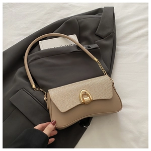 Detail view of khaki sequined shoulder bag with gold horseshoe clasp and chain strap