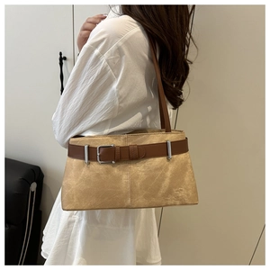 Detail of light khaki suede shoulder bag with brown leather belt buckle and silver metal hardware