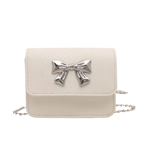 Chic cream mini crossbody bag with snakeskin texture and silver metal bow detail