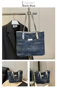 Macro shot of dark blue denim tote bag with starry patterns and silver hardware details