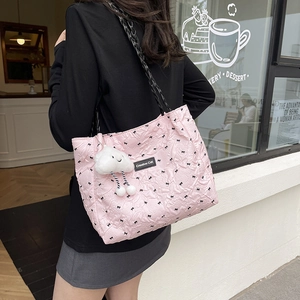 Pink quilted bow tote bag with black chain strap and cloud charm for daily commute