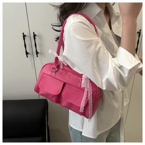 Détail du sac bowling rose vif avec poches fonctionnelles et nœud en dentelle blanche