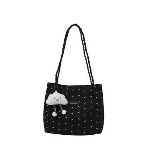 Pleated black tote bag with white bows and a cloud plush charm on a white background