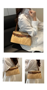 Detail of light camel suede shoulder bag with decorative brown belt and silver buckle