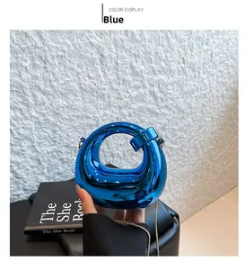 Detail of blue circular metallic acrylic clutch bag with shiny gold metal chain strap