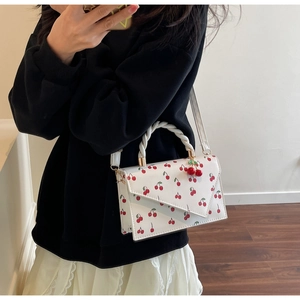 White cherry pattern handbag styled with lace skirt for a fresh summer look