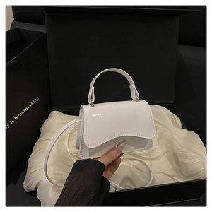 Mini white glossy patent leather bag with wave flap in a luxury silk lined gift box