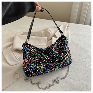 Detailed shot of sparkling multi-color sequin handbag with chain strap and top handle