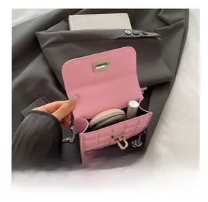 Internal view of pink quilted flap bag showing capacity with makeup items inside