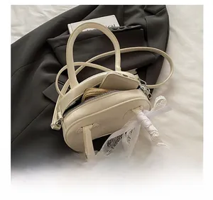 Detail showing the inner capacity of this white lace bow pillow bag with daily essentials