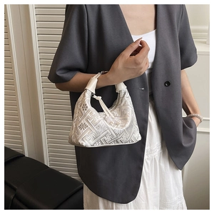 Detail of white jacquard handbag with traditional Chinese floral embroidery pattern