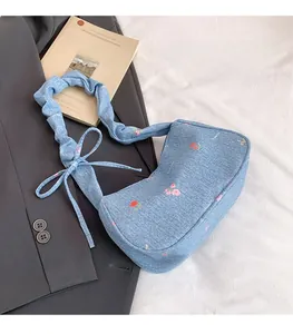 Floral denim shoulder bag with scrunchie strap and ribbon bow detail on the side