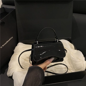 Elegant black patent leather mini square handbag with top handle and slim crossbody strap