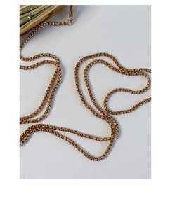 Close-up of a polished gold metal box chain strap with high-gloss finish on a white background
