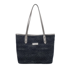 Blue denim tote bag with white polka dots and long leather shoulder straps