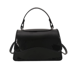 Minimalist black patent leather trapezoid shoulder bag with top handle for women