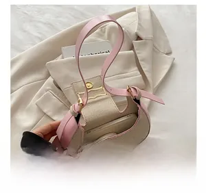 Internal view of pink woven crescent bag showing capacity for a smartphone