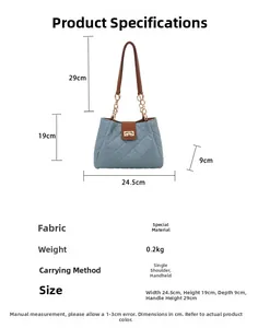 Detail of blue quilted tote bag with brown handles and dimensions 24.5x19x9cm