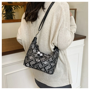 Detail of Chinese style embroidery shoulder bag with pearl accents and ethnic pattern