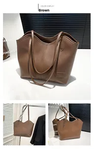 Detail of a brown leather tote bag with FASHION BAGS logo and litchi grain texture