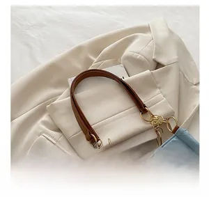 Close-up of light blue quilted crossbody bag with gold twist lock and chain handle